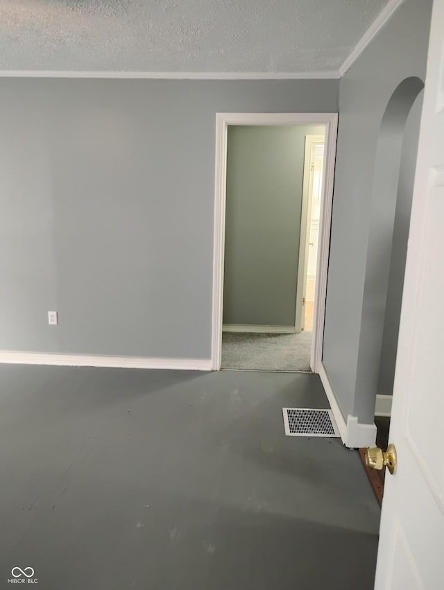 94 N Routiers Ave, Indianapolis, IN 46219 - spare room with arched walkways, ornamental molding, and concrete floors