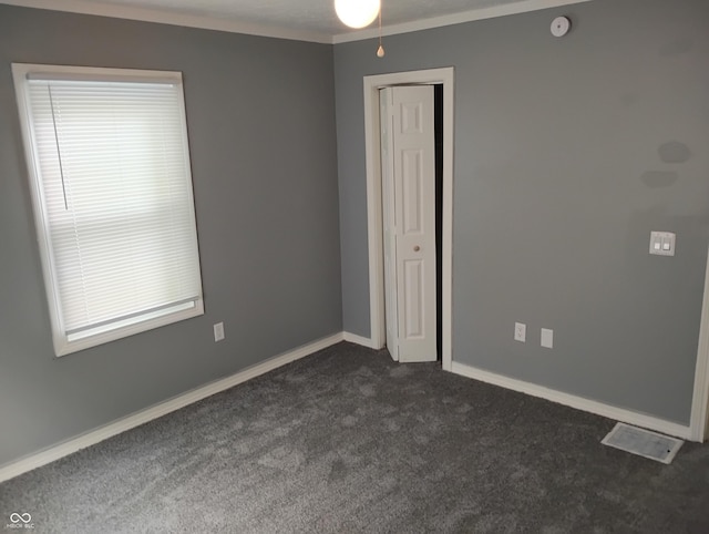 94 N Routiers Ave, Indianapolis, IN 46219 - unfurnished room with dark carpet and crown molding