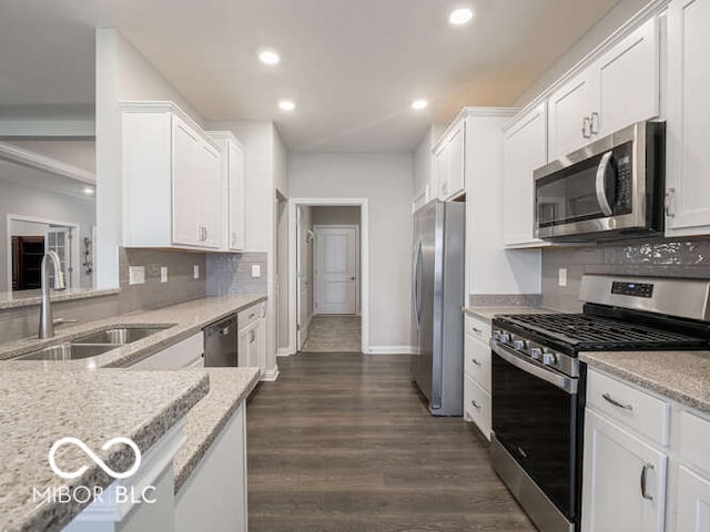 8866 Twain Ln, Indianapolis, IN 46239 - kitchen with appliances with stainless steel finishes, white cabinetry, light stone countertops, and recessed lighting
