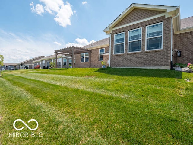 8866 Twain Ln, Indianapolis, IN 46239 - rear view of property with a pergola, brick siding, and a yard