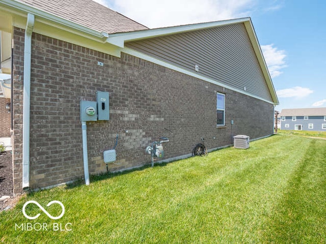 8866 Twain Ln, Indianapolis, IN 46239 - view of side of home featuring brick siding and a yard