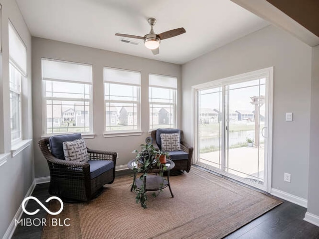 8866 Twain Ln, Indianapolis, IN 46239 - living area with plenty of natural light, a ceiling fan, and dark wood-type flooring