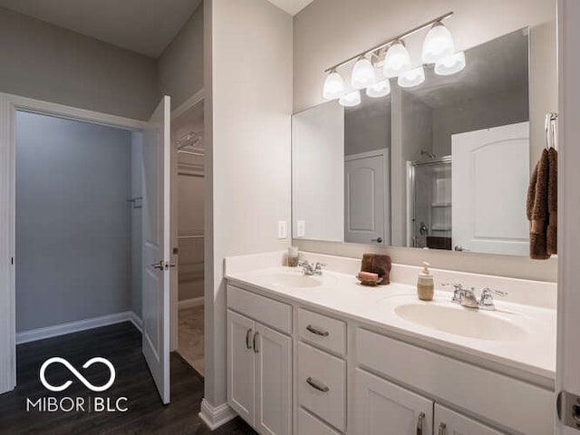 8866 Twain Ln, Indianapolis, IN 46239 - full bath with double vanity, a stall shower, and wood finished floors