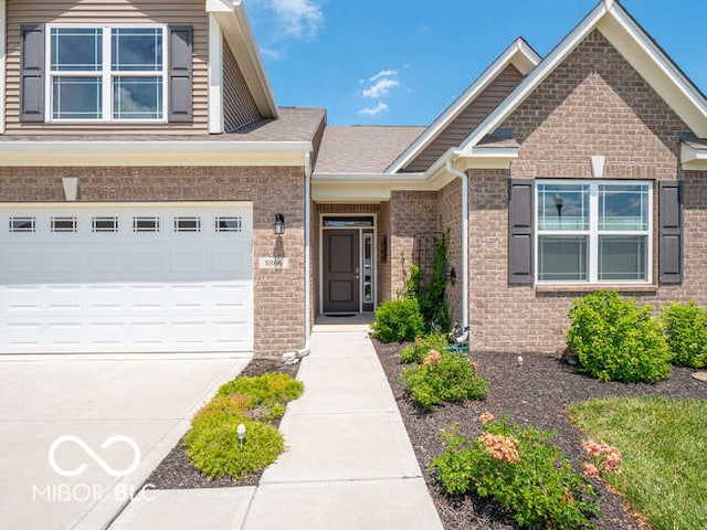 8866 Twain Ln, Indianapolis, IN 46239 - view of front of property featuring brick siding, concrete driveway, and a garage