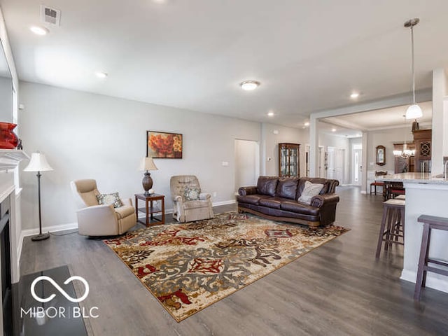 8866 Twain Ln, Indianapolis, IN 46239 - living room with dark wood finished floors, a fireplace, and recessed lighting