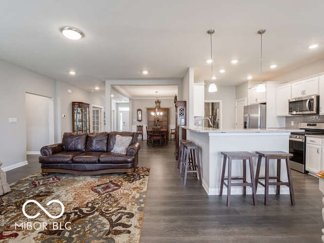 8866 Twain Ln, Indianapolis, IN 46239 - living area featuring dark wood finished floors and recessed lighting