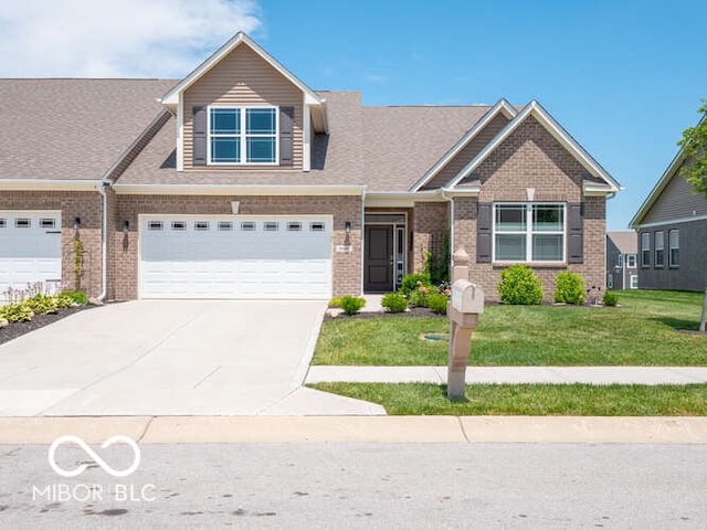 8866 Twain Ln, Indianapolis, IN 46239 - view of front of house with driveway, an attached garage, a front yard, and brick siding