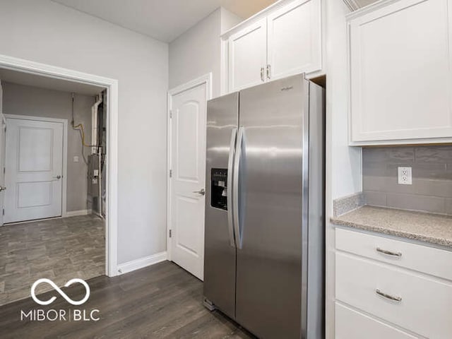 8866 Twain Ln, Indianapolis, IN 46239 - kitchen featuring stainless steel refrigerator with ice dispenser, white cabinetry, dark wood-style floors, backsplash, and light stone counters
