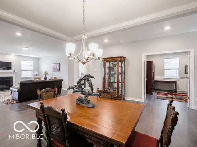 8866 Twain Ln, Indianapolis, IN 46239 - dining area featuring a chandelier, wood finished floors, ornamental molding, recessed lighting, and a fireplace