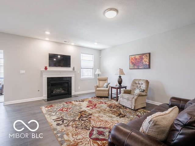 8866 Twain Ln, Indianapolis, IN 46239 - living room featuring a fireplace with flush hearth, wood finished floors, and recessed lighting