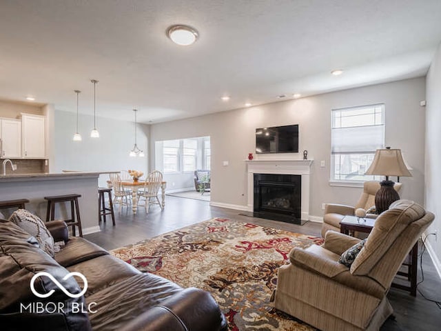 8866 Twain Ln, Indianapolis, IN 46239 - living area featuring a fireplace with flush hearth, recessed lighting, and wood finished floors