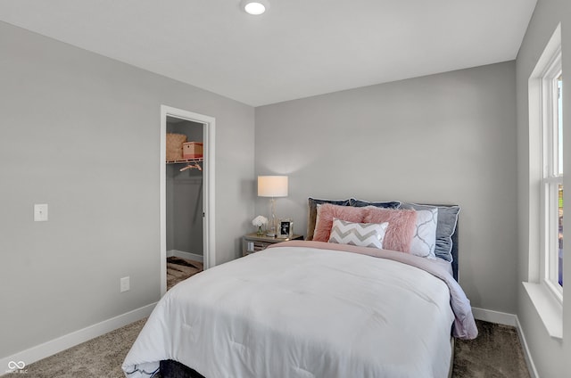 7681 Marin Pkwy, Cumberland, IN 46229 - bedroom featuring dark colored carpet and a walk in closet