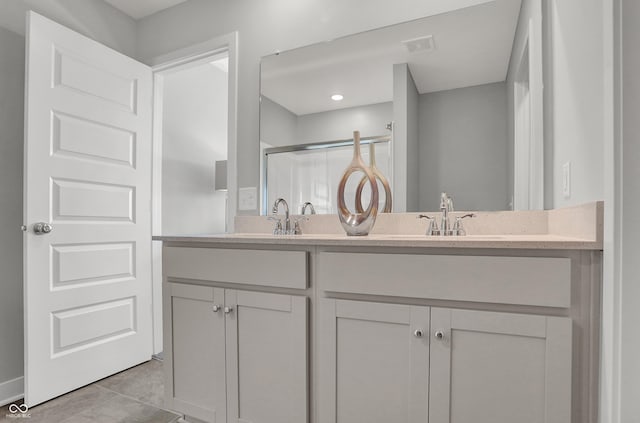 7681 Marin Pkwy, Cumberland, IN 46229 - full bathroom featuring double vanity, a shower stall, and tile patterned flooring
