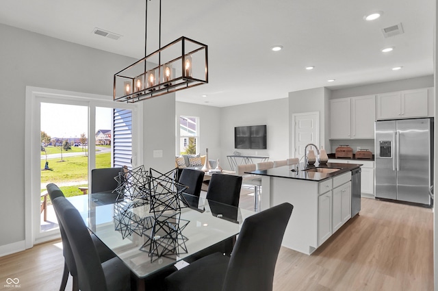 7681 Marin Pkwy, Cumberland, IN 46229 - dining space featuring light wood finished floors, recessed lighting, and a chandelier