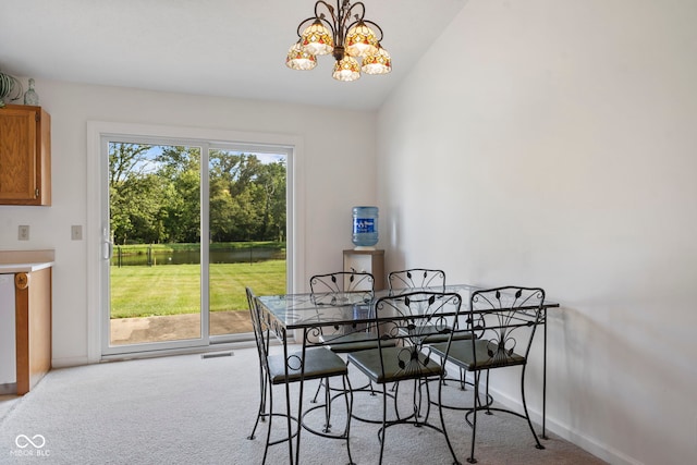1016 W Creek Ridge Dr, Fountaintown, IN 46130 - dining room with carpet, a chandelier, and vaulted ceiling