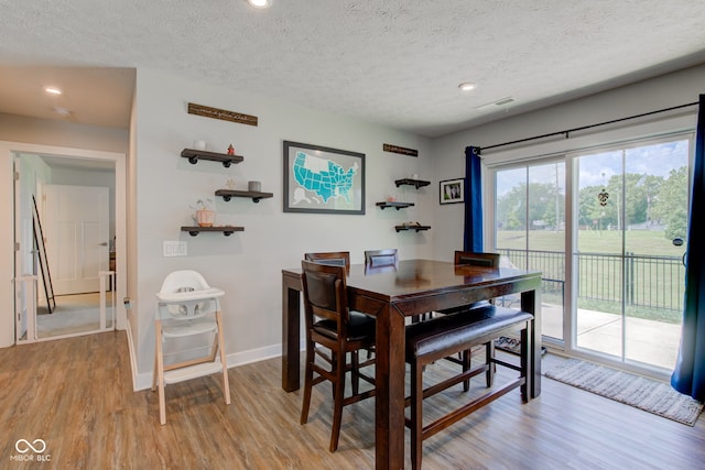 2500 Sand Hollow Dr, Lebanon, IN 46052 - dining space with light wood-style flooring, a textured ceiling, and recessed lighting