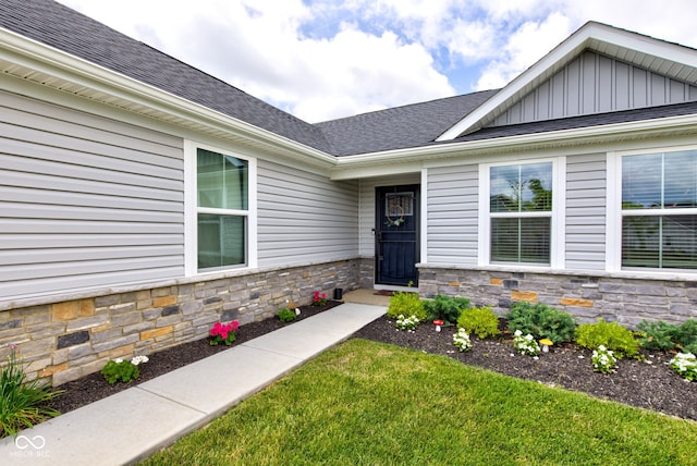 2500 Sand Hollow Dr, Lebanon, IN 46052 - property entrance featuring board and batten siding, stone siding, roof with shingles, and a lawn