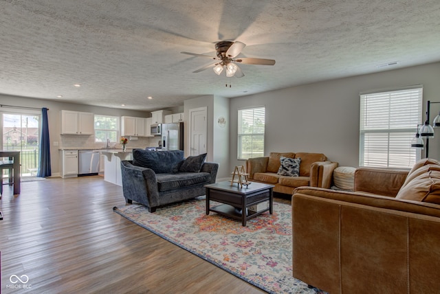 2500 Sand Hollow Dr, Lebanon, IN 46052 - living room with light wood-type flooring, ceiling fan, a textured ceiling, and recessed lighting
