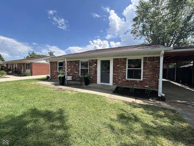 2845 12th St, Columbus, IN 47201 - single story home with a front lawn, an attached carport, and brick siding