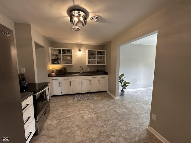 2845 12th St, Columbus, IN 47201 - kitchen featuring appliances with stainless steel finishes, dark countertops, open shelves, and white cabinets