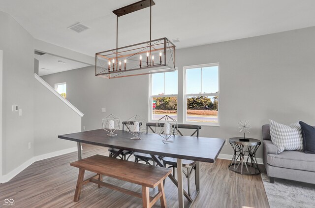 7675 Marin Pkwy, Cumberland, IN 46229 - dining room with wood finished floors and a chandelier