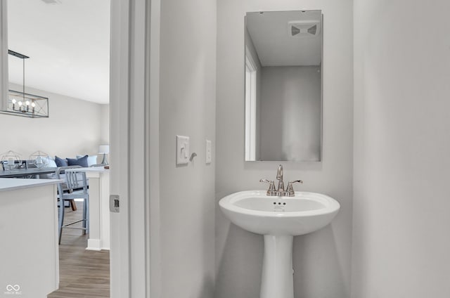 7675 Marin Pkwy, Cumberland, IN 46229 - bathroom with wood finished floors and a chandelier