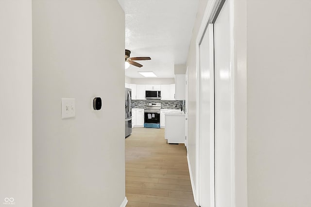 5015 Nowland Ave, Indianapolis, IN 46201 - hallway with a sink and light wood-style flooring