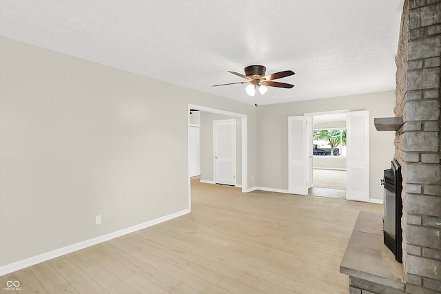 5015 Nowland Ave, Indianapolis, IN 46201 - unfurnished living room with a ceiling fan, light wood-type flooring, and a textured ceiling