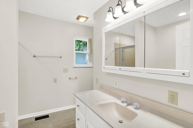5015 Nowland Ave, Indianapolis, IN 46201 - full bath featuring vanity, a shower stall, and wood finished floors