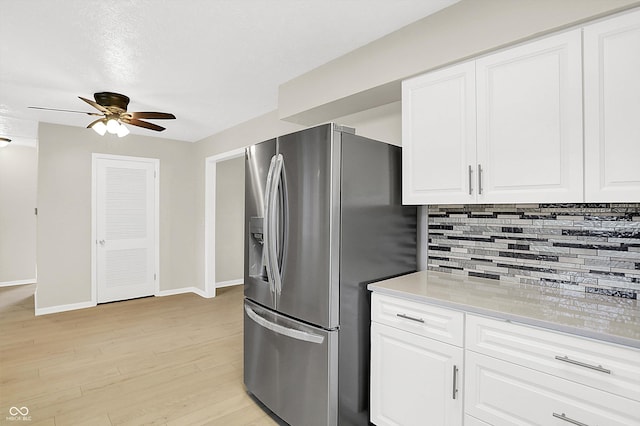 5015 Nowland Ave, Indianapolis, IN 46201 - kitchen featuring stainless steel fridge with ice dispenser, ceiling fan, tasteful backsplash, and white cabinets