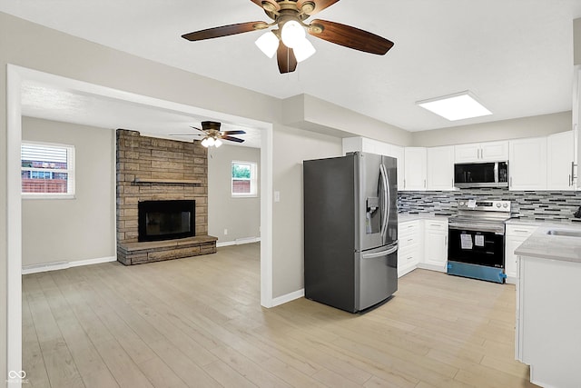 5015 Nowland Ave, Indianapolis, IN 46201 - kitchen featuring stainless steel appliances, open floor plan, ceiling fan, and light countertops