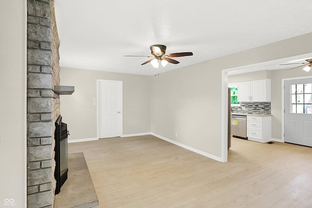 5015 Nowland Ave, Indianapolis, IN 46201 - unfurnished living room with a ceiling fan, a multi sided fireplace, and light wood-type flooring