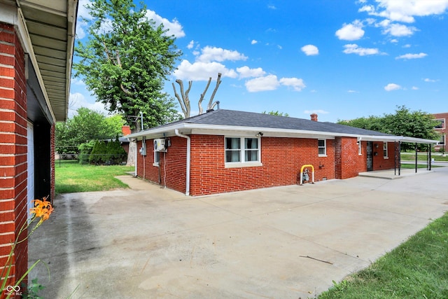 5015 Nowland Ave, Indianapolis, IN 46201 - back of property featuring brick siding, roof with shingles, a patio, and a chimney