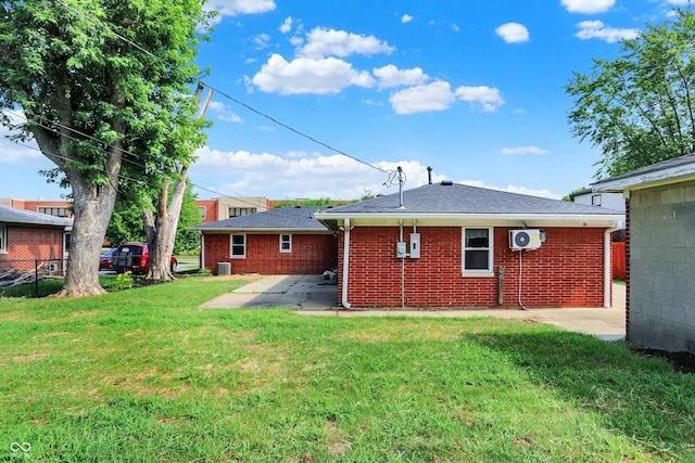 5015 Nowland Ave, Indianapolis, IN 46201 - back of house featuring a patio, a yard, and brick siding