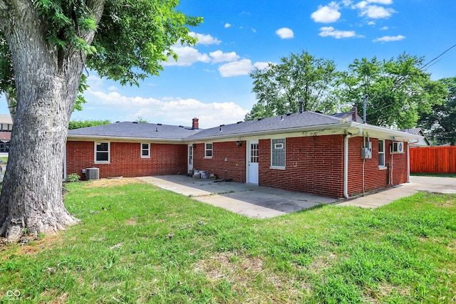 5015 Nowland Ave, Indianapolis, IN 46201 - rear view of house with brick siding, a patio area, and a chimney