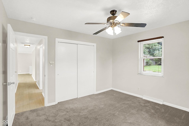 5015 Nowland Ave, Indianapolis, IN 46201 - unfurnished bedroom featuring carpet floors, a closet, and ceiling fan