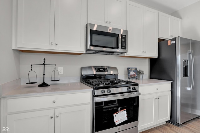 7687 Marin Pkwy, Cumberland, IN 46229 - kitchen featuring appliances with stainless steel finishes, light countertops, and white cabinetry