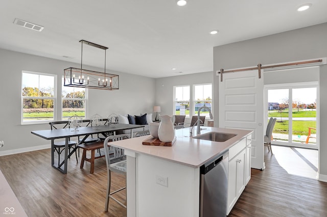 7687 Marin Pkwy, Cumberland, IN 46229 - kitchen featuring stainless steel dishwasher, dark wood finished floors, an island with sink, light countertops, and recessed lighting