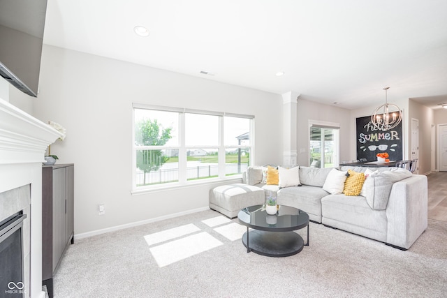 7147 Prelude Rd, Brownsburg, IN 46112 - living room featuring a fireplace, a chandelier, ornate columns, light carpet, and recessed lighting