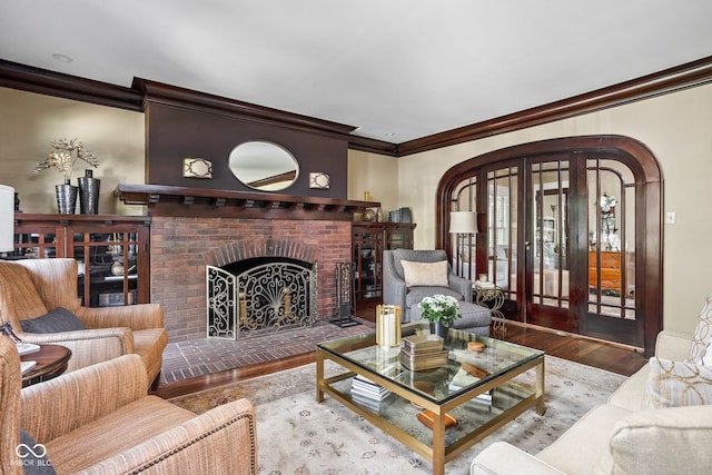 4455 Broadway St, Indianapolis, IN 46205 - living area featuring crown molding, wood finished floors, arched walkways, a fireplace, and french doors