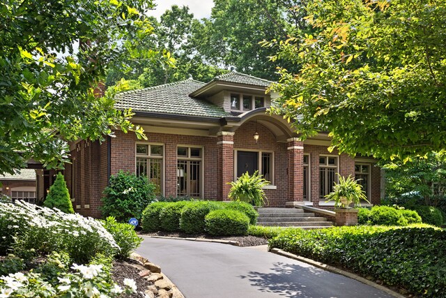 4455 Broadway St, Indianapolis, IN 46205 - view of front of home featuring brick siding and a tiled roof