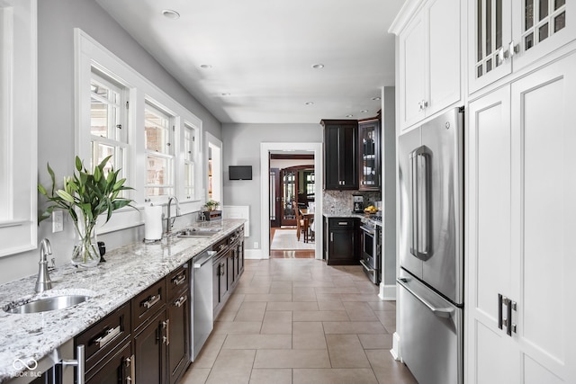 4455 Broadway St, Indianapolis, IN 46205 - kitchen with premium appliances, glass insert cabinets, healthy amount of natural light, and recessed lighting