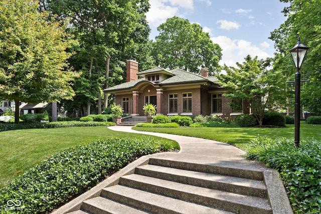 4455 Broadway St, Indianapolis, IN 46205 - view of front of property featuring a chimney, brick siding, and a front yard