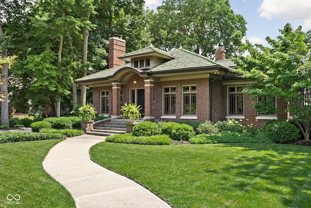 4455 Broadway St, Indianapolis, IN 46205 - view of front of home featuring a chimney, a front lawn, brick siding, and a tile roof