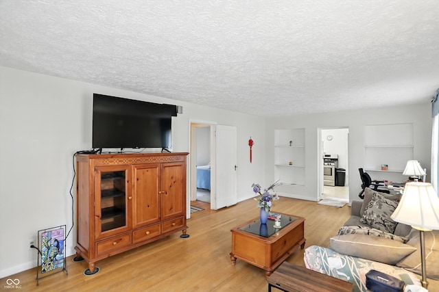 95 S 11th Ave, Beech Grove, IN 46107 - living area with light wood-type flooring, a textured ceiling, and built in shelves