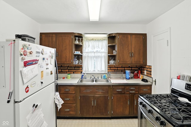 95 S 11th Ave, Beech Grove, IN 46107 - kitchen with freestanding refrigerator, stainless steel gas range oven, open shelves, light countertops, and backsplash