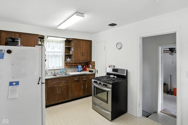 95 S 11th Ave, Beech Grove, IN 46107 - kitchen featuring freestanding refrigerator, stainless steel gas range oven, open shelves, light countertops, and light floors