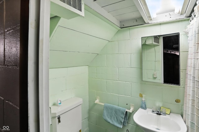 95 S 11th Ave, Beech Grove, IN 46107 - bathroom with concrete block wall and vaulted ceiling