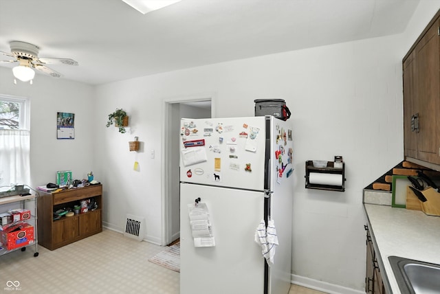 95 S 11th Ave, Beech Grove, IN 46107 - kitchen featuring freestanding refrigerator, a ceiling fan, and light countertops