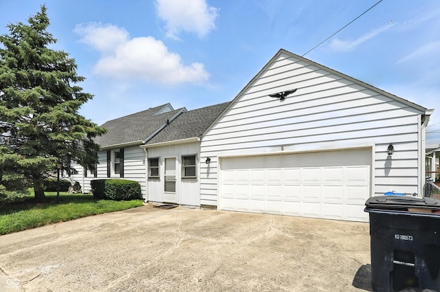 95 S 11th Ave, Beech Grove, IN 46107 - view of front of home with roof with shingles, concrete driveway, and a garage